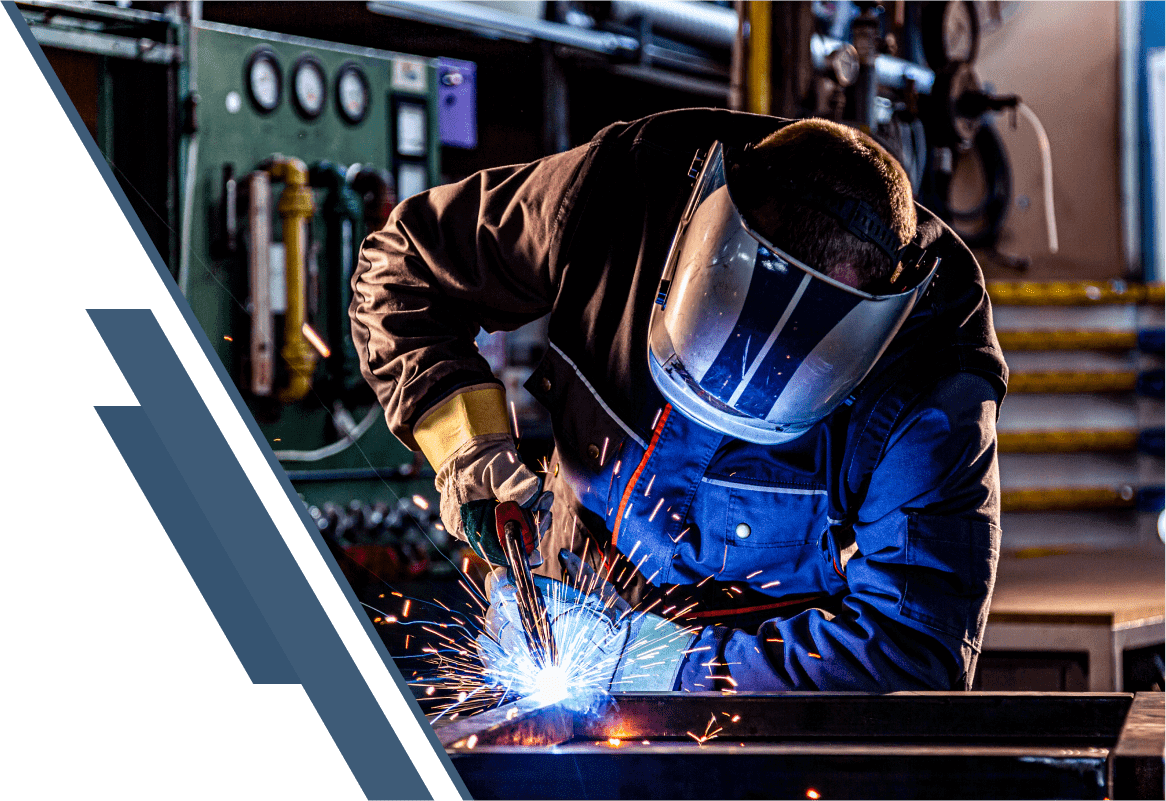 Welder working with sparks in workshop.